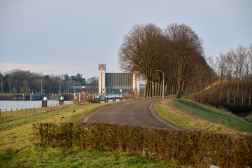 Heumen lock complex from the dike with beautiful tree-lined avenue