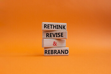 Rethink Revise and Rebrand symbol. Wooden blocks with words Rethink Revise and Rebrand. Beautiful orange background. Business and Rethink Revise and Rebrand concept. Copy space.