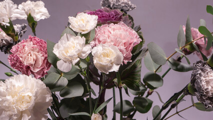 Beautiful bouquet of pink, grey and white carnation flowers, fresh eucalyptusas and violet brassica flower.