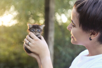 Happy teen female with tiny kitten