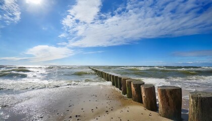 baltic sea blue sky wave sea and wooden waterbreak