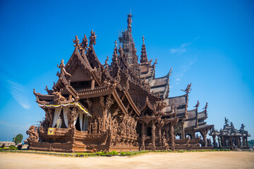 Sanctuary of Truth wooden temple in Pattaya Thailand is a gigantic wood construction located at the cape of Naklua Pattaya City. Sanctuary of Truth temple.  - obrazy, fototapety, plakaty