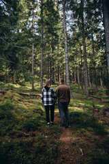 family young couple in the mountains, autumn forest. a man and a woman went to the mountains. clothes and shoes for trekking. Man and a woman went on a mountain trip. CARPATHIAN MOUNTAINS