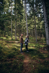 Fototapeta na wymiar family young couple in the mountains, autumn forest. a man and a woman went to the mountains. clothes and shoes for trekking. Man and a woman went on a mountain trip. CARPATHIAN MOUNTAINS
