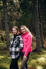 two women travel through the mountains. go on a hike with friends