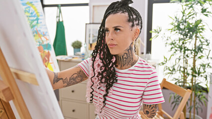 Brave hispanic woman amputee, a passionate art student, harnessing creativity through drawing at a cozy art studio