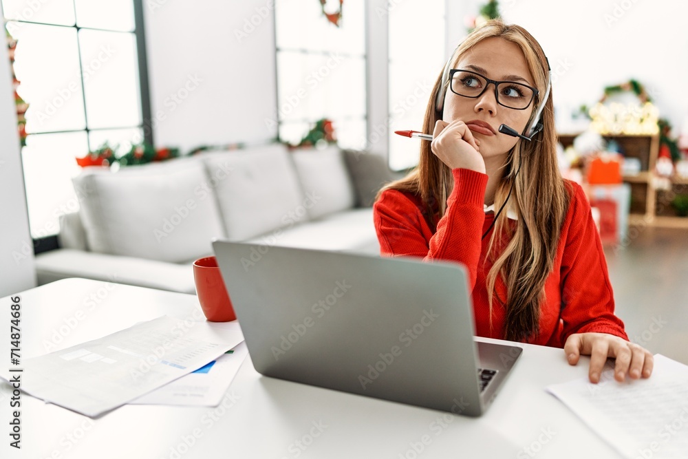 Sticker young caucasian woman call center agent teleworking sitting by christmas tree at home