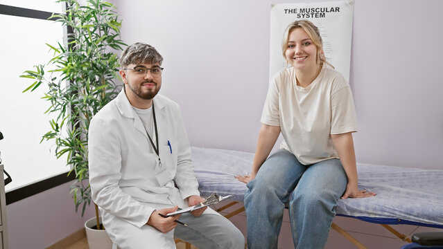 A man therapist in a clinic engages with a smiling woman patient during a physiotherapy session.