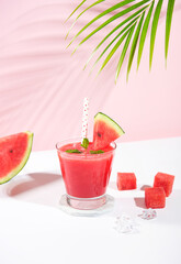 Fresh watermelon juice and watermelon slice on pastel color background. cooling beverage summer...
