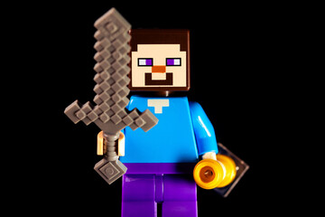 Fototapeta premium LEGO Minecraft man with a sword on a black background