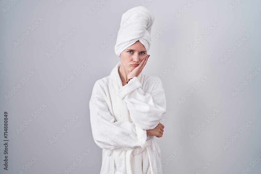 Poster Blonde caucasian woman wearing bathrobe thinking looking tired and bored with depression problems with crossed arms.