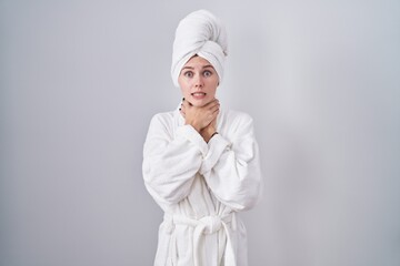 Blonde caucasian woman wearing bathrobe shouting suffocate because painful strangle. health problem. asphyxiate and suicide concept.