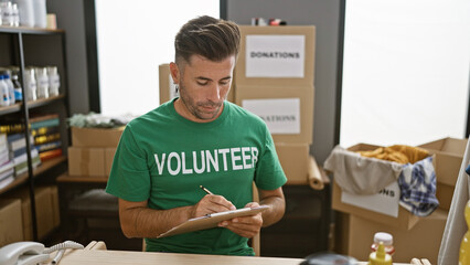 Hardworking young hispanic man volunteering, a serious portrait of charitable work at community...
