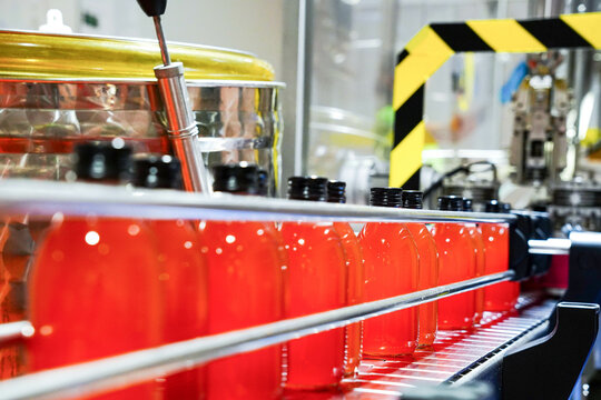 Bottles filled with liquid on an assembly line