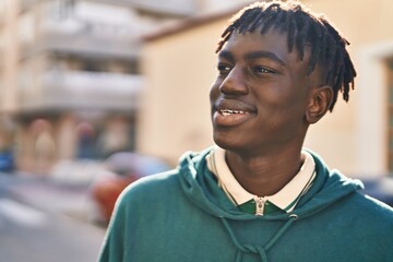 Fototapeta premium African american man smiling confident looking to the side at street