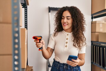 Young beautiful hispanic woman ecommerce business worker scanning package at office