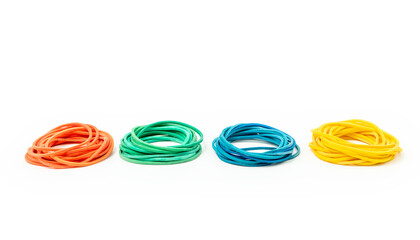 Stacks of different rubber bands on white background. Red, green, blue and yellow rubber bands