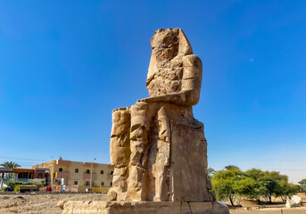 Fototapeta na wymiar Colossi of Memnon, two massive stone statues representing the pharaoh, Luxor, Egypt