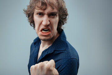 Ready to confront, fierce scowl, fist raised