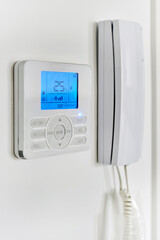 Video intercom with talkback or doorphone voice communications system mounted on wall, close up...