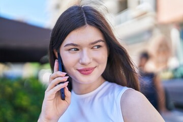 Young caucasian woman smiling confident talking on the smartphone at street