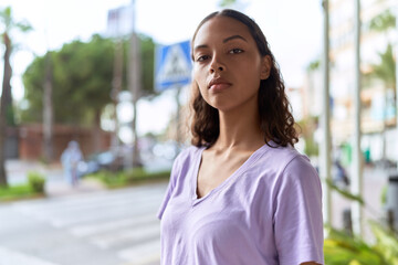 Young african american woman standing with serious expression at street