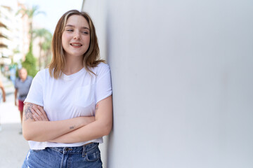 Obraz premium Young caucasian woman standing with arms crossed gesture at street