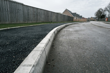 Newly laid asphalt on a pedestrian walk way leading to a new bungalow housing development in the...