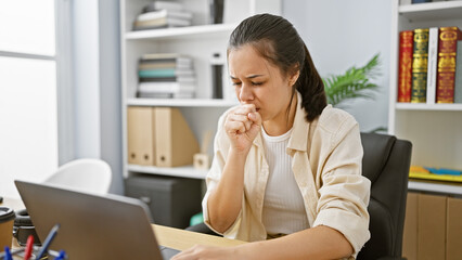 Coughing attack hits beautiful young hispanic woman while working hard at her office job amid...