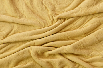Yellow leather texture with folds used as a classic background.