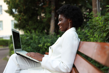 happy african businesswoman working with laptop