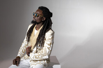  stylish african man in a shiny jacket and sunglasses