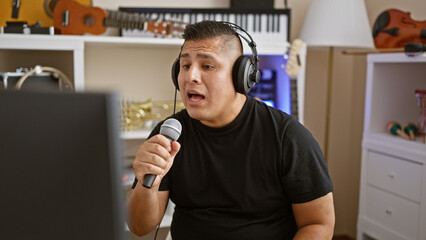 Striking portrait, serious young latin man, a professional musician, totally engrossed singing his...