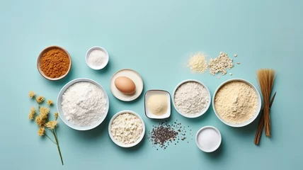 Poster Top-down view of baking ingredients on a pastel blue background, arranged neatly with a sense of minimalism © deafebrisa