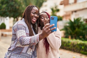 African american women friends smiling confident having video call at park