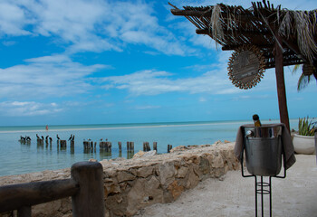 Champagne on the beach with blue skies in Holbox Mexico.