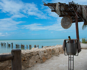 Champagne on the beach with blue skies in Holbox Mexico.