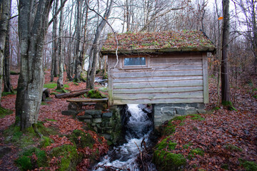 Unique wooden house built over a small creek with running water. Rogaland Norway