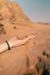 Hand with rocks in Wadi Rum - Jordan