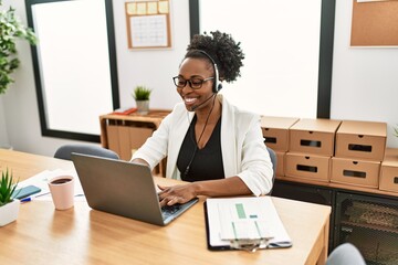 African american woman call center agent smiling confident working at office