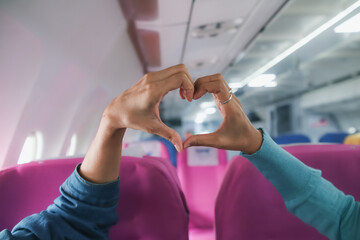 lover raises her hands and makes heart symbol express meaning of love friendship and kindness...