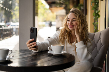 Selfie in a coffee shop. Relaxed female person and happy lady with social media, cafe and...