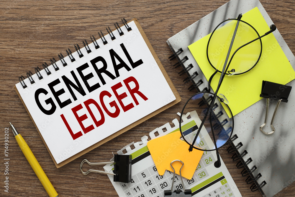 Poster general ledger text on a notepad on a wooden table