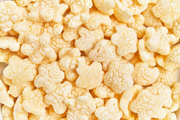 Top view of numerous crisp rice cakes in a full-frame background, suggesting a healthy snack option.