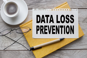 DATA LOSS PREVENTION yellow notepad and glasses. text on paper