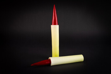 Hot pepper and leek in the form of ammunition. The concept of healthy eating. On a white background.