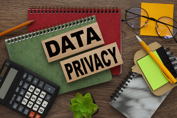 DATA PRIVACY red and green notepad on a work desk. text on wooden blocks