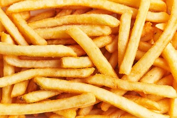 Close-up of crispy golden french fries filling the frame, perfect for food and restaurant themes.