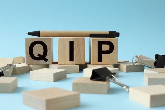QIP blue background. text on wooden blocks