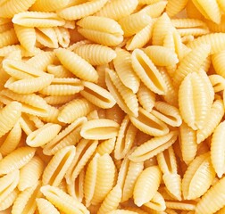 Close-up of uncooked italian fusilli pasta forming a textured background, suitable for culinary themes.